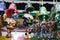 An assortment of colorful hanging bells with patterned designs on display for sale