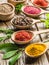 Assortment of colorful spices in the wooden spoons.