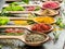 Assortment of colorful spices in a wooden spoons.