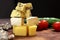 Assortment of different cheese type on a wooden board. Different pieces of cheese, blue cheese, moldy cheese, camembert and