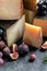 Assortment of different cheese types with grapes and figs. Cheese background. traditional pieces of Spanish, French, Italy cheese