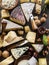 Assortment of different cheese types on stone background. Top view
