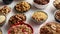 Assortment of different kinds cereals placed in ceramic bowls on table