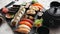 Assortment of different kinds of sushi rolls placed on black stone board