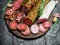 Assortment of different salami with spices and herbs