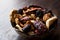 Assortment dried fruits; Apple apricot mulberry cranberry date raspberry red raisin and fig in bowl.