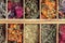 Assortment of dried relaxing tea herbs in wood tea box close up.