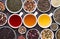 Assortment of dried tea leaves, fruit and herbs in bowls  and cups of tea