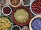 Assortment of dry herbs: chamomile, hawthorn berry, rosehip, calendula, dandelion root, thyme flat on rustic textile, from above o