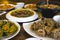 An assortment of Filipino cuisine on a wood table at a local restaurant. Included food are Mussels and Calamari, among other