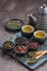 Assortment of fragrant dried teas and green tea on wooden table