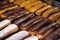 Assortment of french fresh baked eclair sweet pastry  in confectionery shop