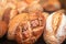 Assortment of Fresh Bread as background, top view.  Rustic loaves of bread close up