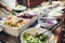 Assortment of fresh dishes displayed in hotel buffet. Variety of food in canteen ready for dinner