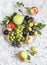 Assortment of fresh fruit - grapes, pears, apples, plums on a light background