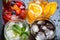 Assortment of fresh iced fruit drinks on a dark background