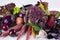 Assortment of fresh raw purple homegrown vegetables on white table.