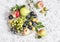 Assortment of fresh summer fruit - grapes, pears, apples, plums on a light background