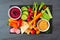 Assortment of fresh vegetables and hummus dip on a serving platter, above view on slate