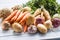 Assortment of fresh vegetables on wooden table. Carrot parsnip garlic celery onion and kohlrabi