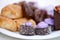 Assortment of freshly prepared organic oriental sweets - cream cakes, Tatar baklava on a white plate. View from above.