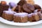 Assortment of freshly prepared organic oriental sweets - cream cakes, Tatar baklava on a white plate. View from above.