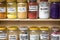 Assortment of glass jars on shelves in herbalist shop on a traditional Moroccan market (souk) in Essaouira, Morocco