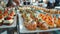 Assortment of gourmet appetizers on white trays