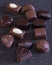 An assortment of gourmet chocolates in various shapes and sizes, featuring rich dark and creamy white chocolate, elegantly