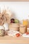 Assortment of grains, cereals and pasta in glass jars and vegetables on wooden table
