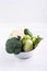 Assortment green vegetables on white table.  Broccoli, cauliflower, brussels sprouts, kohlrabi, avocado, asparagus. Healthy eating