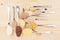 Assortment groats in spoons on soft beige wood board. Healthy food background.