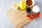 Assortment of herbs,lemons and tomatoes on cutting board. Preparation for cooking meal in the kitchen