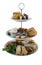 Assortment of high tea delicacies including sandwiches, scones, pies, sweet desserts isolated