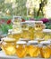 Assortment of honey jars at market stall. Sale of natural honey in fair outdoor