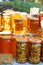 Assortment of honey jars at market stall. Sale of natural honey in fair outdoor