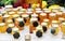 Assortment of honey jars at market stall. Sale of natural honey in fair outdoor