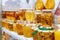 Assortment of honey jars at market stall. Sale of natural honey in fair outdoor