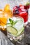 Assortment of iced fruit drinks on wooden background, vertical