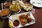 Assortment of Indian dishes for dinner, butter chicken, tikka masala, rice and naan