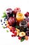 Assortment of jams, seasonal berries, plums, mint and fruits
