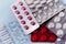 Assortment of medical pills in a package, on a light background, no people, selective focus,