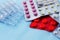 Assortment of medical pills in a package, on a light background, no people, selective focus,