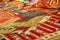 Assortment of Moroccan carpets resting on the ground in a souk