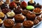 An assortment of mouth-watering cupcakes and muffins arranged beautifully on a tray. Generative-AI