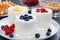 assortment natural yogurt with fresh berries and waffles