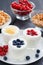 Assortment natural yogurt with fresh berries and waffles