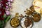 Assortment of nuts in metal bowls hazelnuts, walnuts, almonds with flowers Top view with copy space