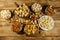 Assortment of nuts on wooden table. Almond, hazelnut, pistachio, peanut, walnut and cashew in small bowls. Top view