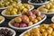 Assortment of olives on the plate in bulk. Close up